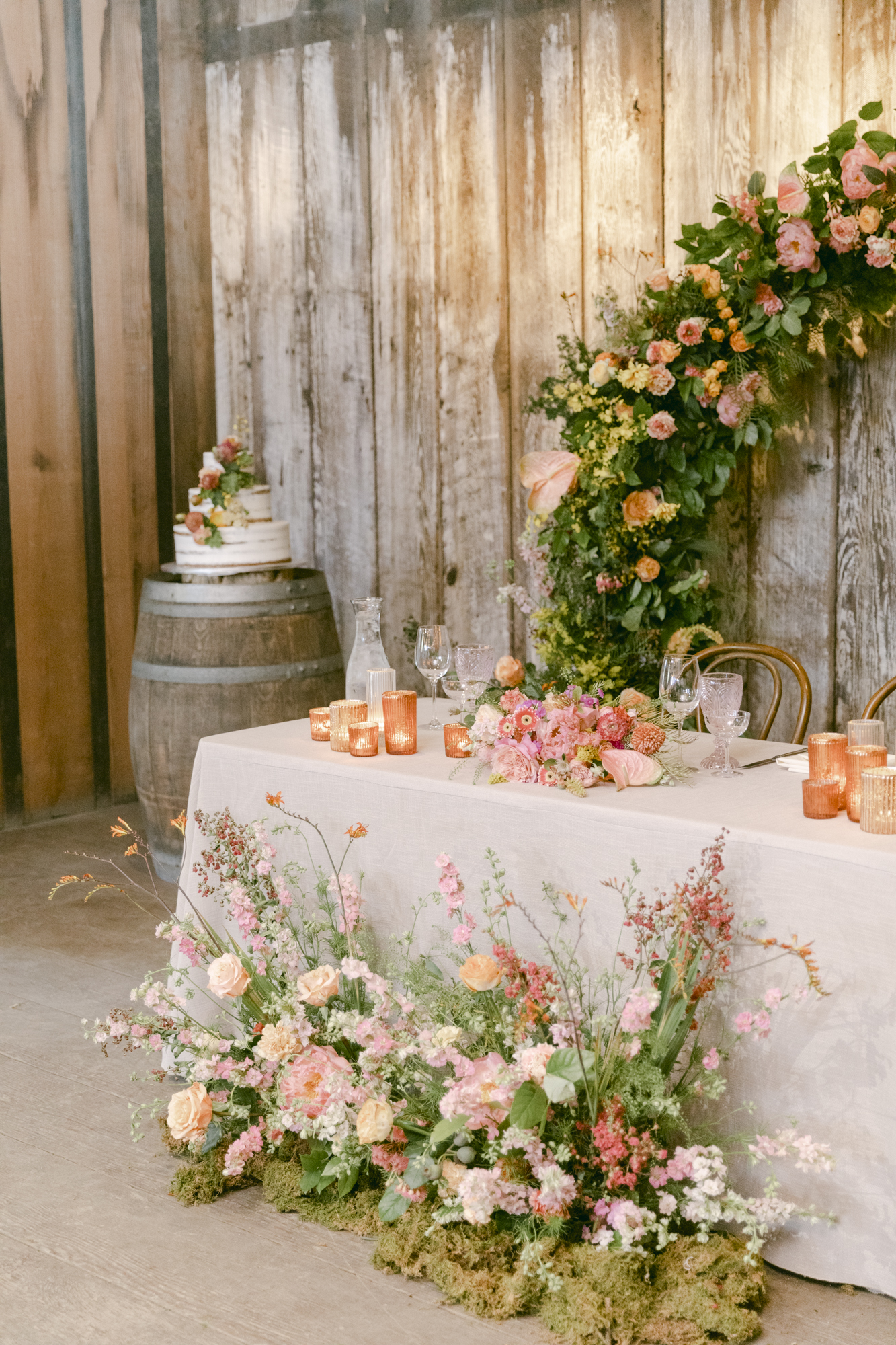 repurposing wedding ceremony florals at the reception table.