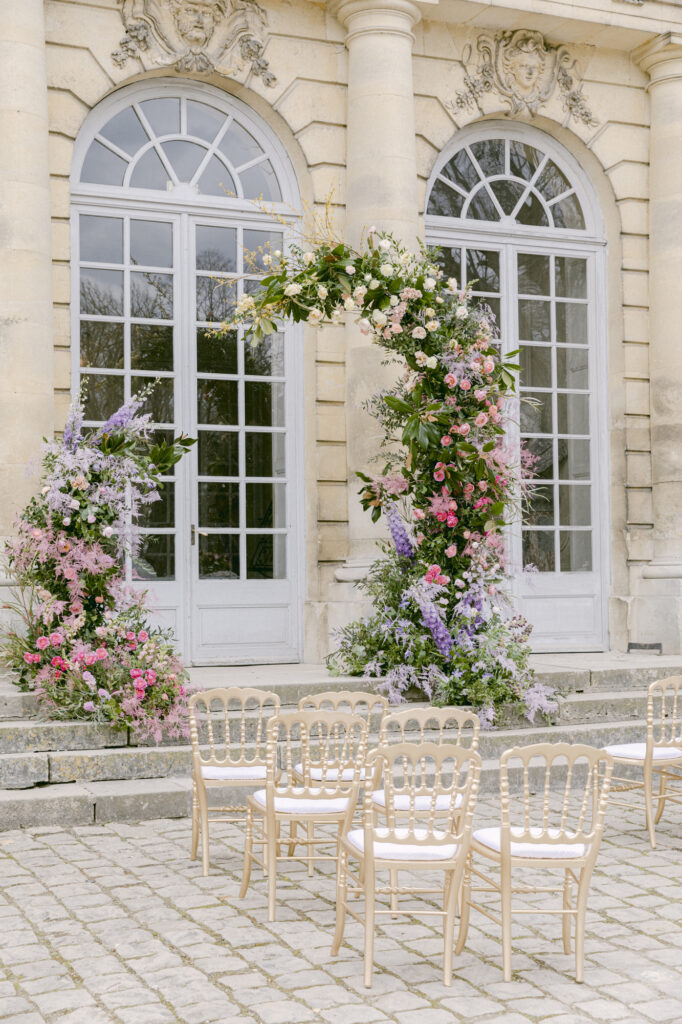 Chateau de Champlatreux Paris, France destination wedding. ceremony site and reception floral arrangements. Luxury destination wedding.
