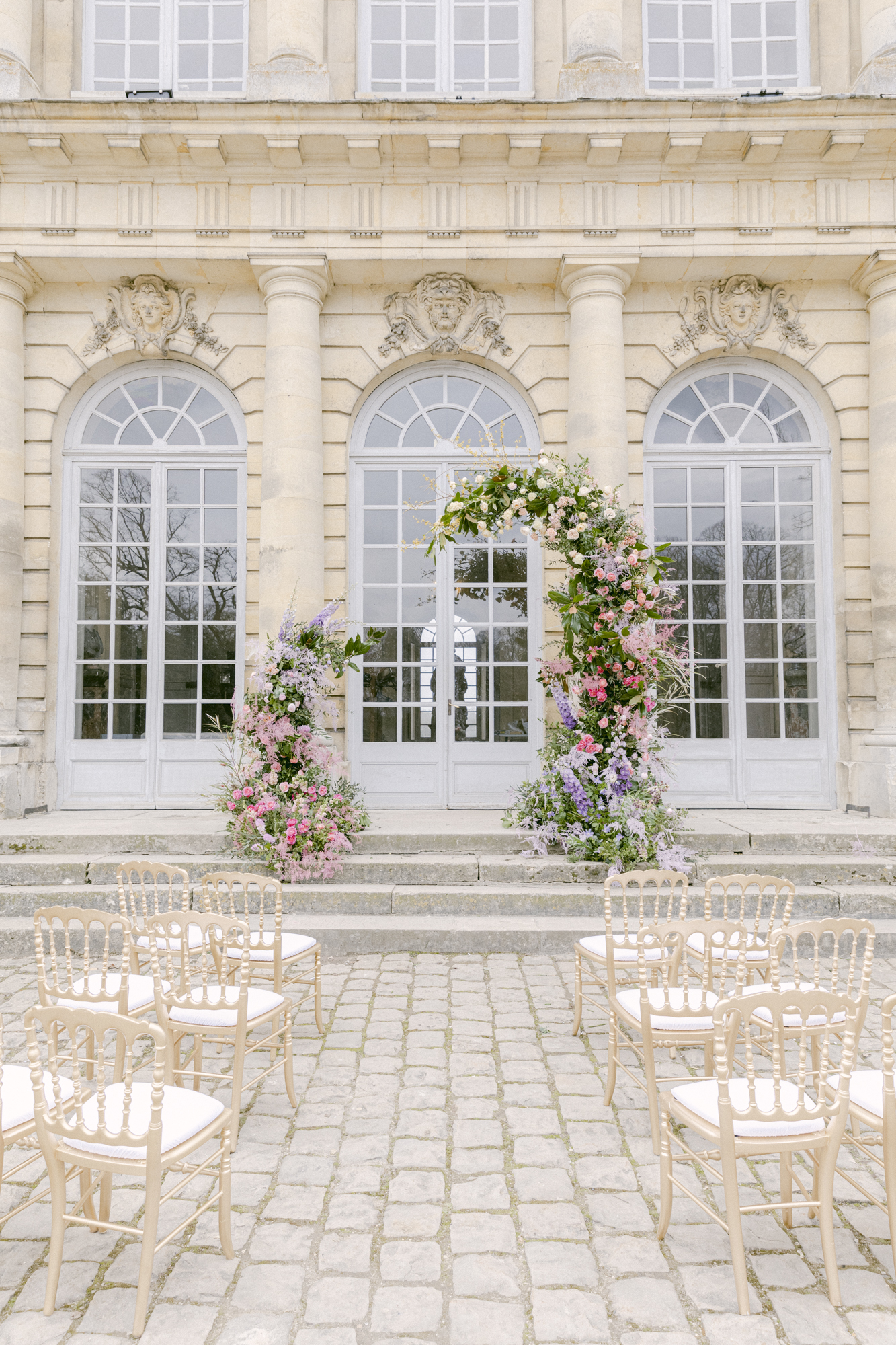 Chateau de Champlatreux Paris, France destination wedding. ceremony site and reception floral arrangements. Luxury destination wedding.