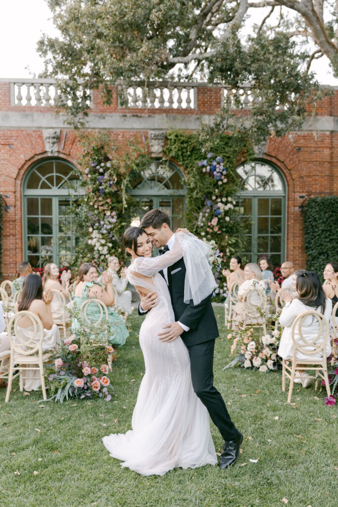 bride and groom kissing after their wedding ceremony