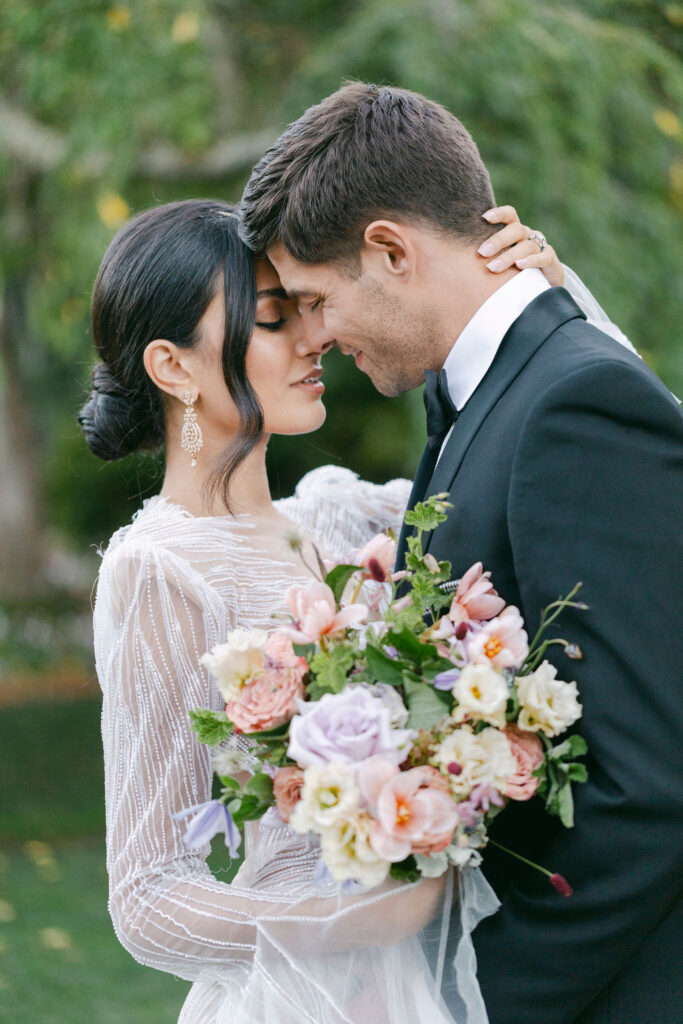 bride and groom smiling at each other 