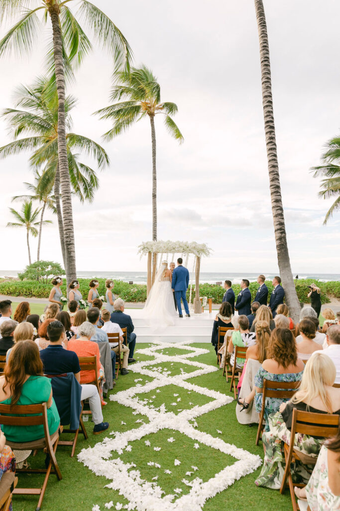 bride and groom holding hands at their wedding ceremony 