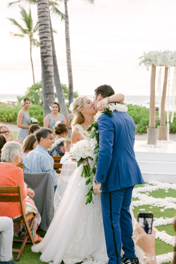 bride and groom kissing after their wedding ceremony 