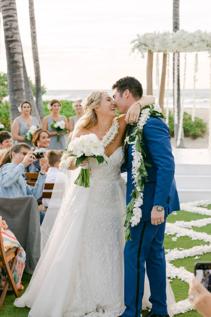 bride and groom kissing after their wedding ceremony 