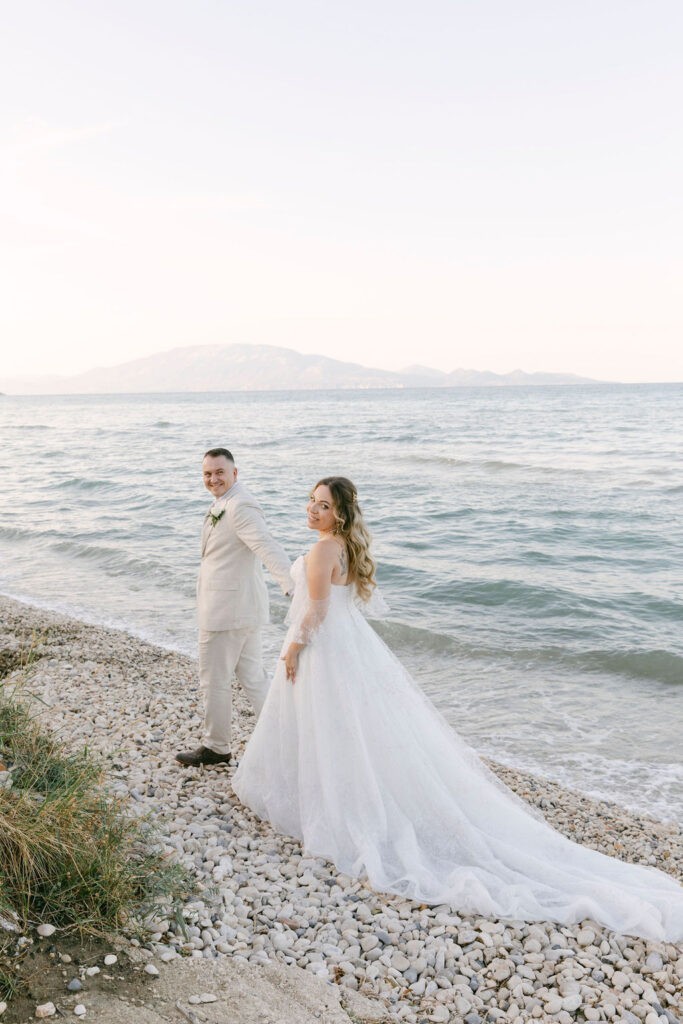 bride and groom walking around the beach 