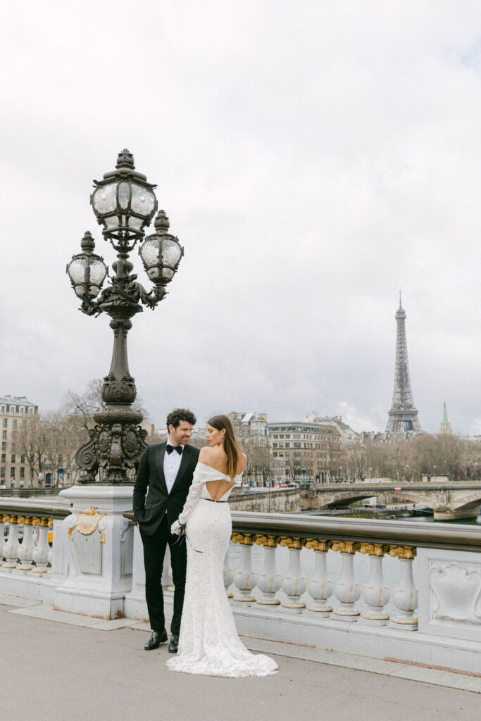 bride and groom hugging at the eiffel tower