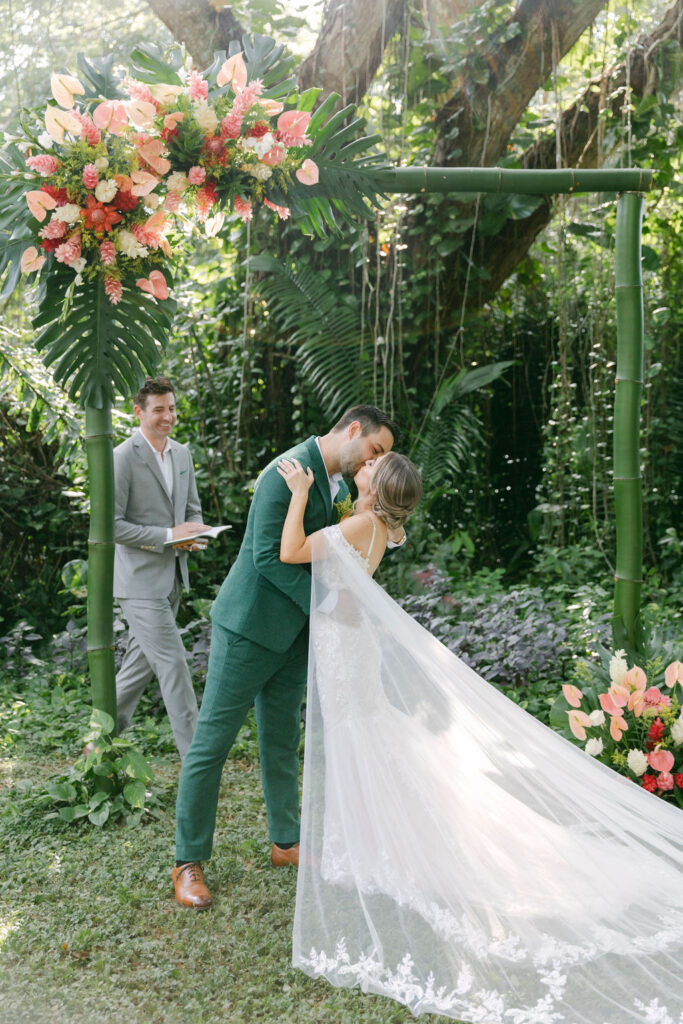 bride and groom kissing after their wedding ceremony 