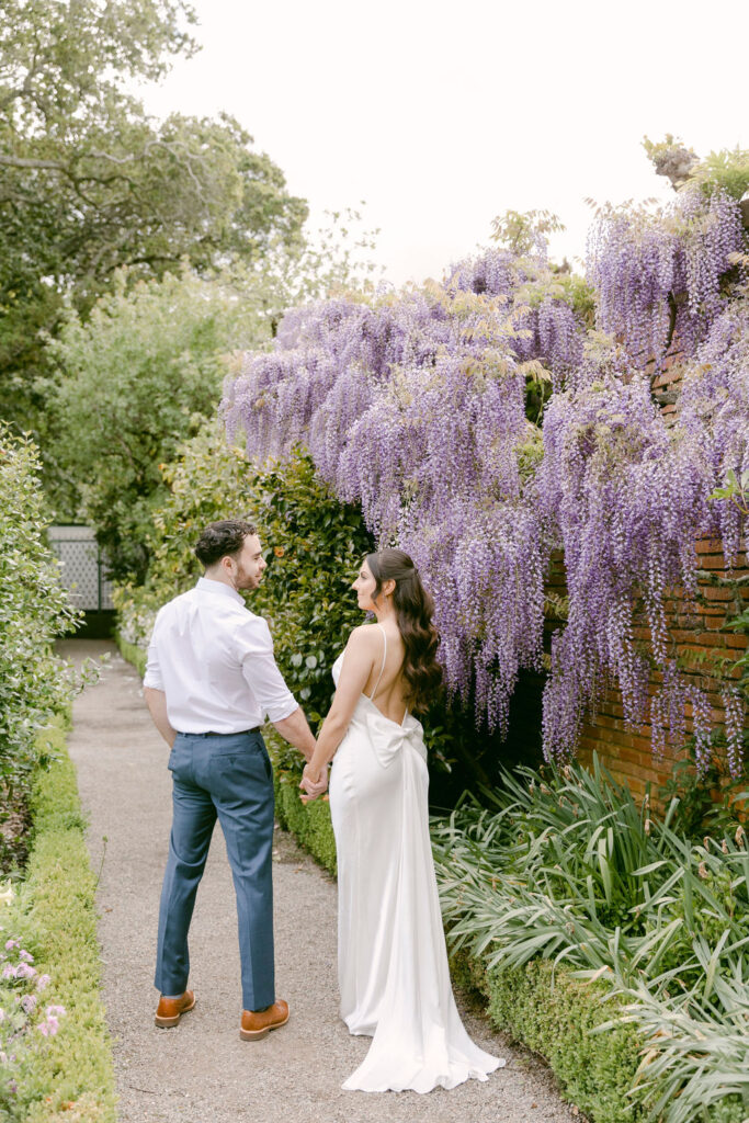 newly engaged couple walking around the garden during their photoshoot