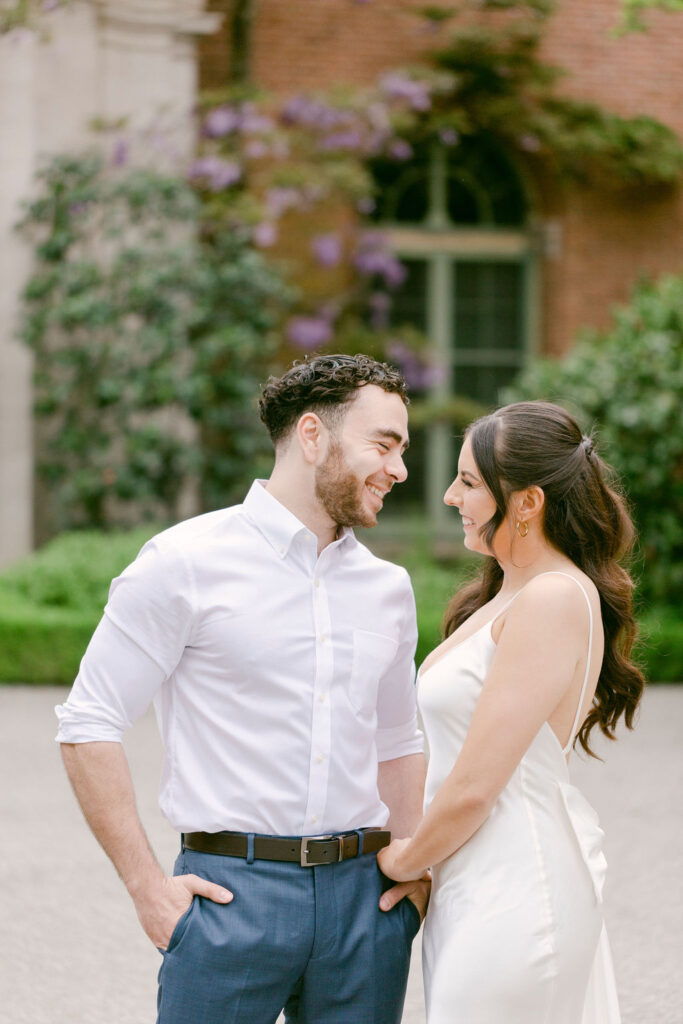 newly engaged couple looking at each other 