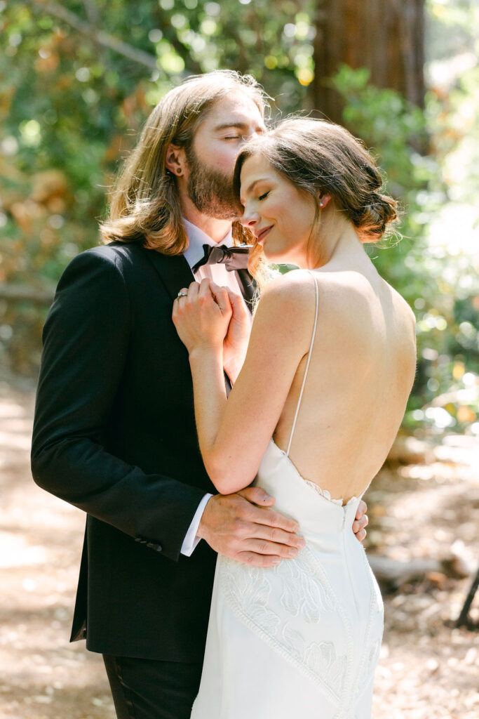 groom kissing the bride on the forehead 