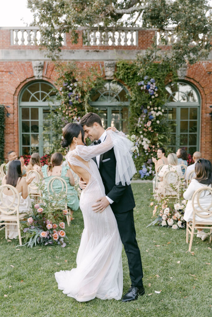 bride and groom kissing after their wedding ceremony