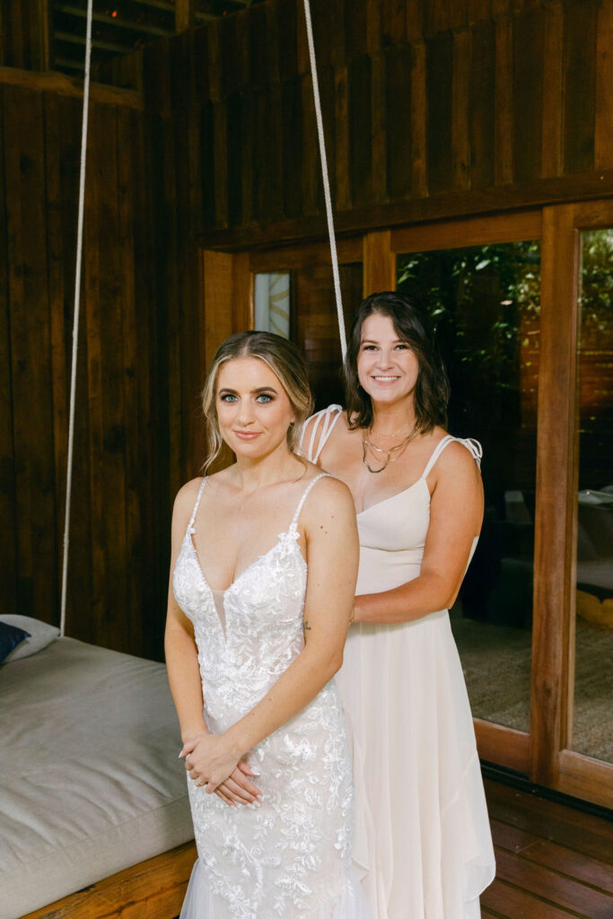 bridesmaid helping the bride get ready for the ceremony