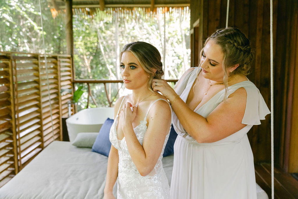 bride putting on her jewelry for her amazing ceremony 