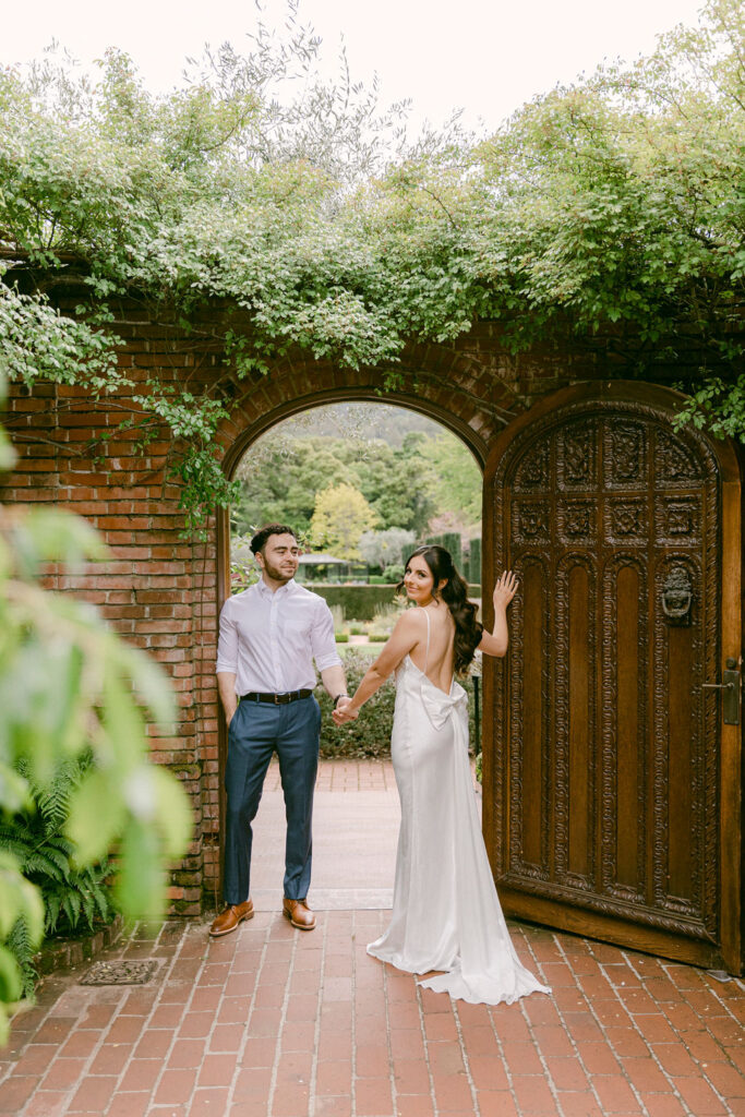 newly engaged couple holding hands