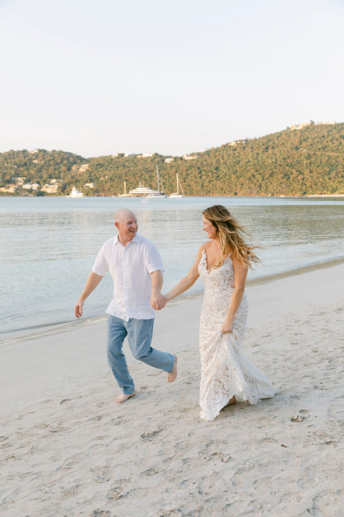 couple running around the beach 