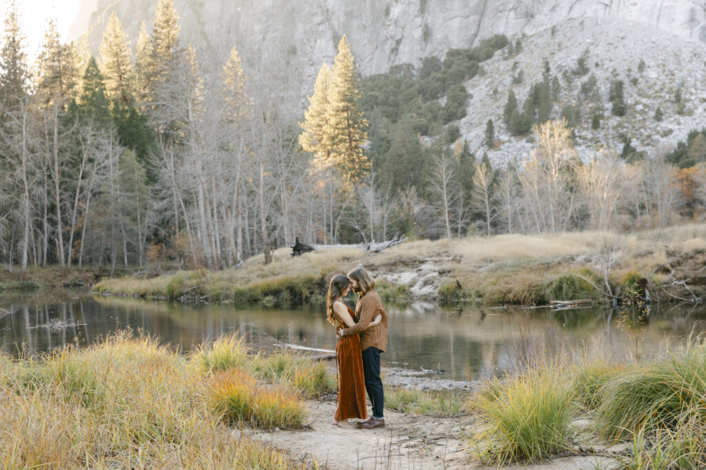 couple holding onto each other during engagement photos at yosemite national park 