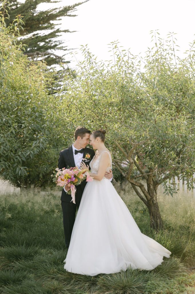 bride and groom hugging during wedding photos in carmel