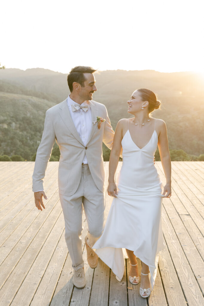 bride and groom walking on pathway during wedding photos in carmel