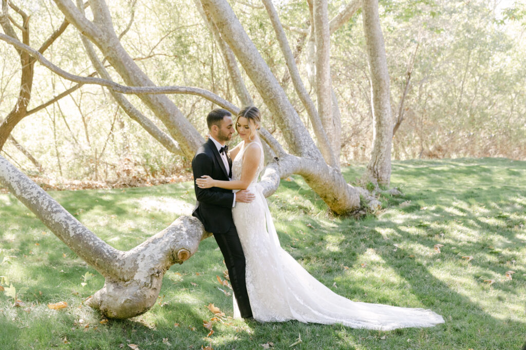 bride and groom standing next to each other during wedding photos in carmel