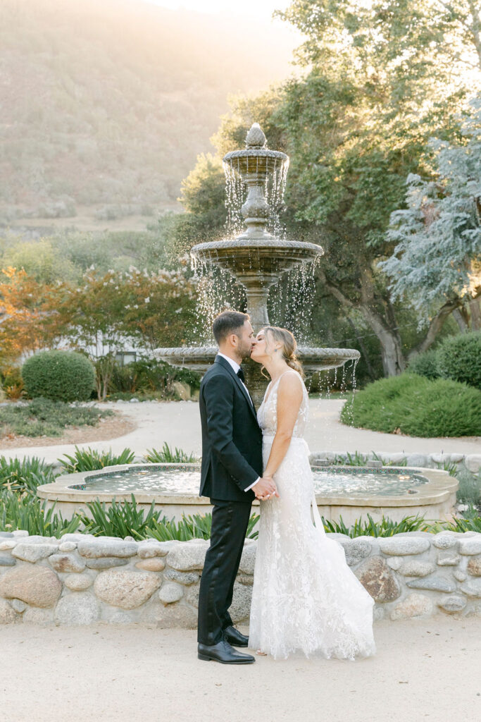 portrait of the newlyweds kissing at their reception