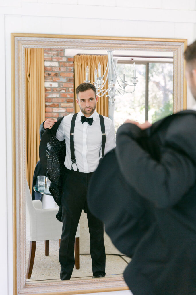 groom getting ready for his timeless summer wedding ceremony