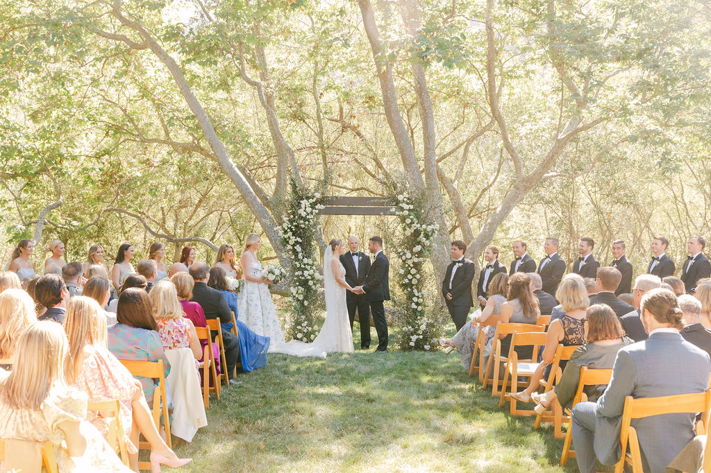 bride and groom holding hands at their timeless ceremony 