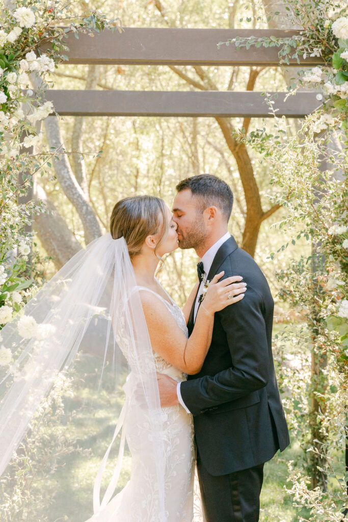 bride and groom kissing after their ceremony