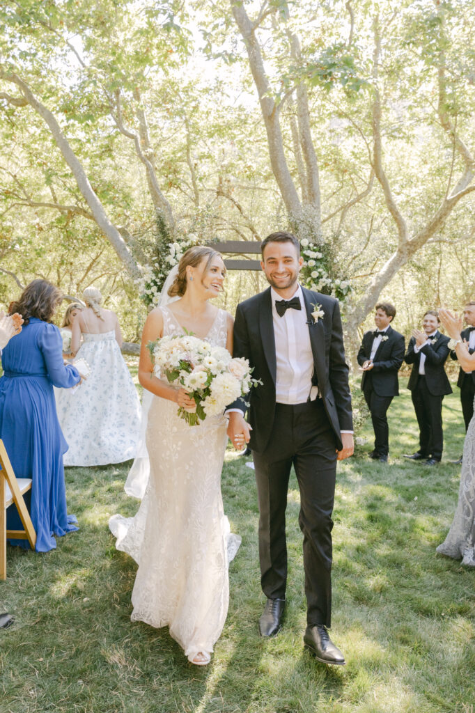 bride and groom standing next to each other during wedding photos in carmel from ceremony