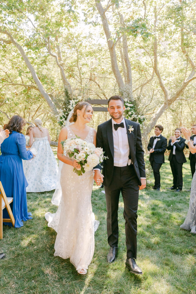 bride and groom heading to their timeless summer wedding reception