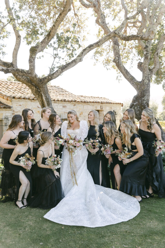 bride with bridesmaids in front of venue in carmel