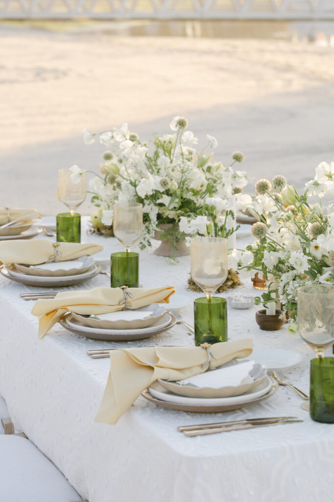 beautiful tablescape with wildflowers, pearls,and beach details, at a San diego beach destination wedding