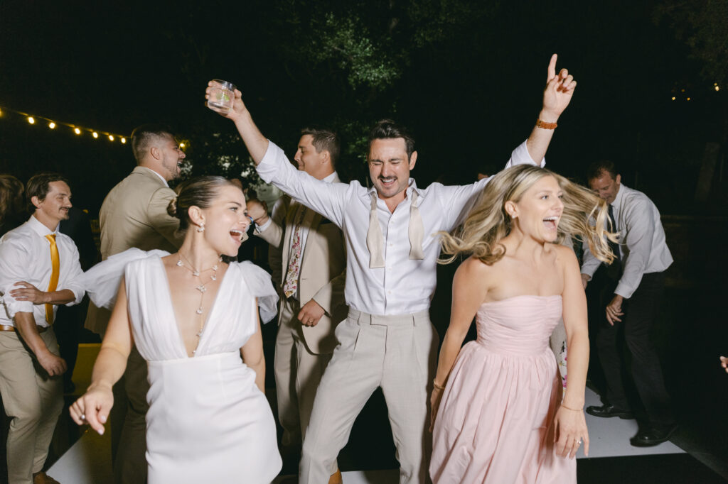 bride, groom, and sister of the bride dancing all night long during their wedding reception at Carmel Valley Ranch