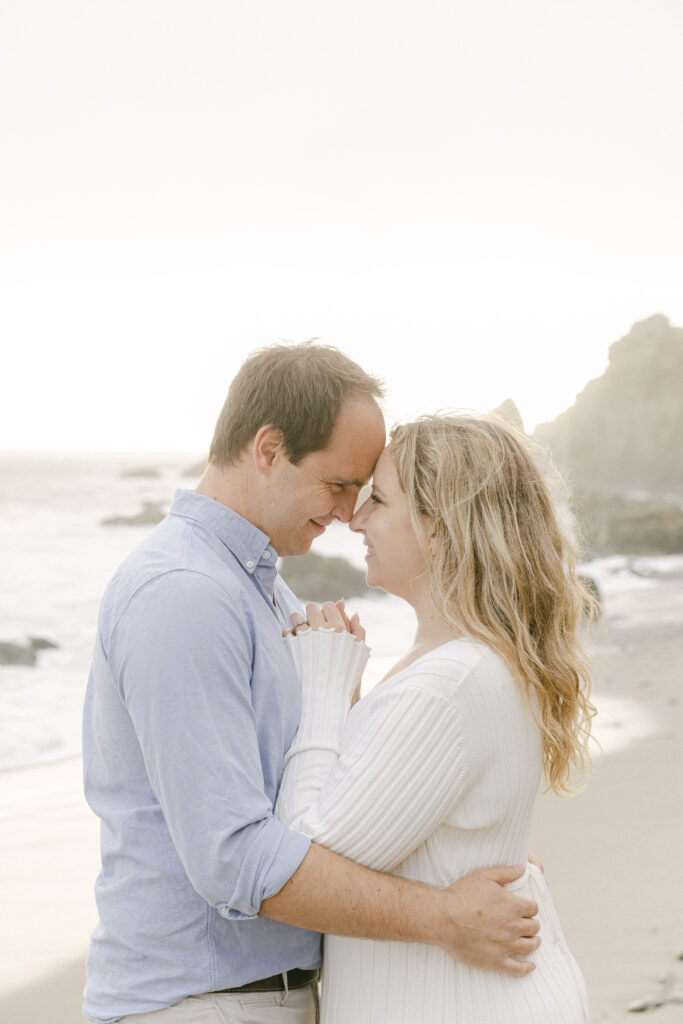 close up of couple embracing and touching foreheads at El Matador Beach during a soft and romantic Malibu engagement session
