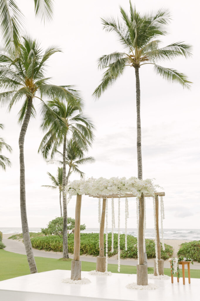 Close-up of a geometric white orchid petal pattern laid on the lawn aisle at a Four Seasons Hualalai wedding ceremony in Hawaii