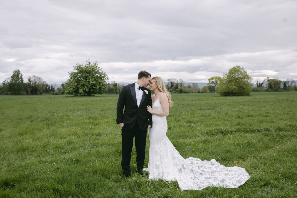Bride and groom share a quiet moment in the green Irish countryside outside Luttrellstown Castle.