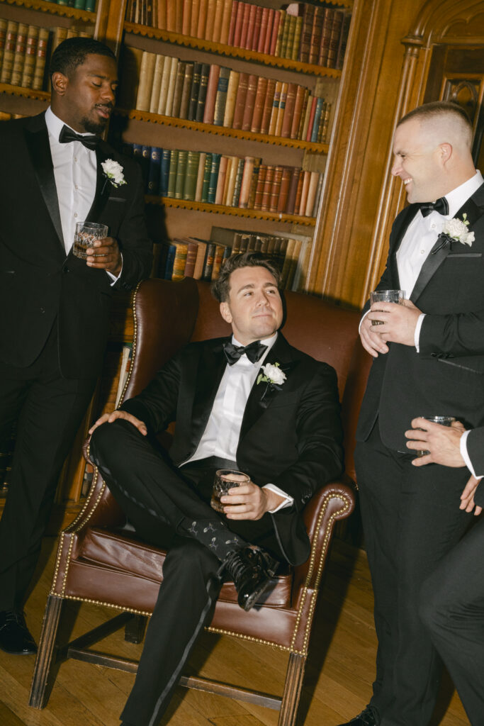 Groom relaxes in the Luttrellstown Castle library with his groomsmen and whiskey before the ceremony.